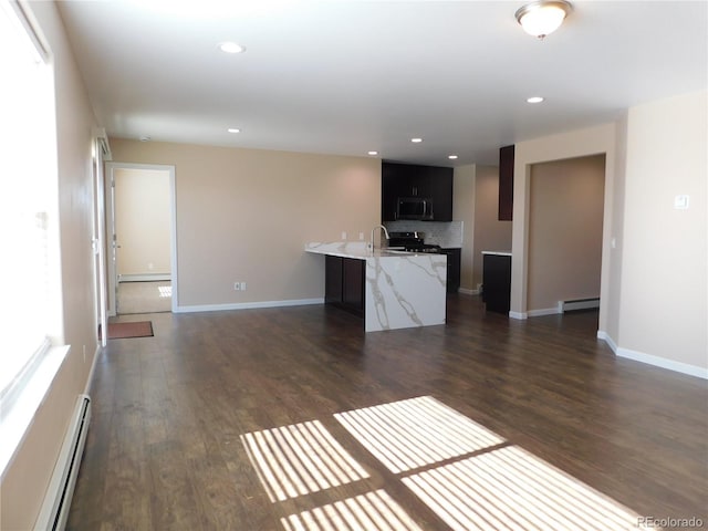 kitchen with recessed lighting, a baseboard heating unit, appliances with stainless steel finishes, baseboard heating, and dark wood finished floors