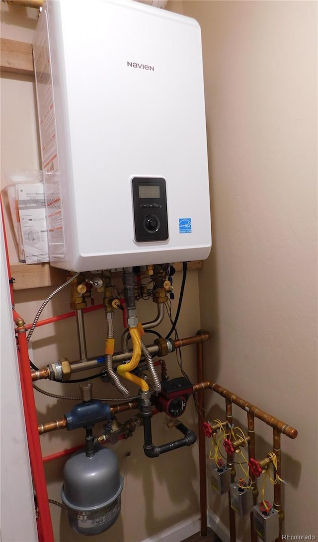 utility room with tankless water heater