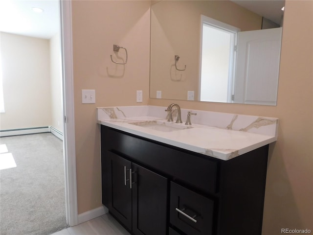 bathroom featuring baseboard heating, vanity, and baseboards