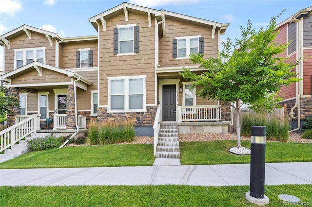 13870 Ash Cir, Brighton, CO 80602 - craftsman house with a porch, stone siding, and a front yard