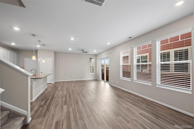 13870 Ash Cir, Brighton, CO 80602 - unfurnished living room with recessed lighting, stairway, wood finished floors, and a ceiling fan
