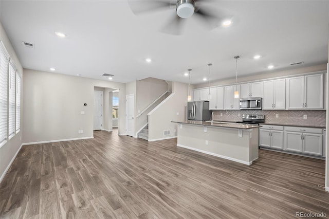 13870 Ash Cir, Brighton, CO 80602 - kitchen featuring appliances with stainless steel finishes, decorative backsplash, ceiling fan, wood finished floors, and recessed lighting