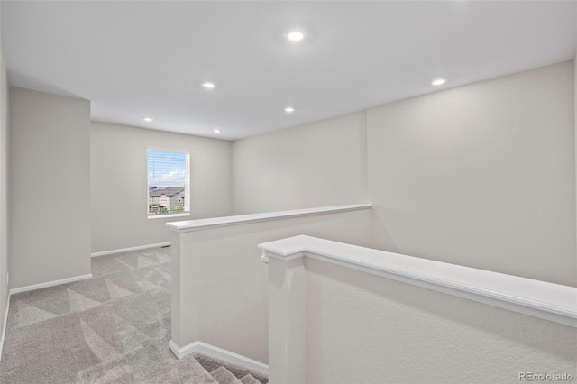 13870 Ash Cir, Brighton, CO 80602 - hallway with light carpet, recessed lighting, and an upstairs landing