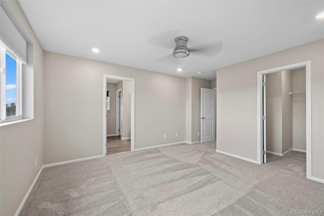 13870 Ash Cir, Brighton, CO 80602 - unfurnished bedroom featuring carpet flooring, a walk in closet, a ceiling fan, and recessed lighting