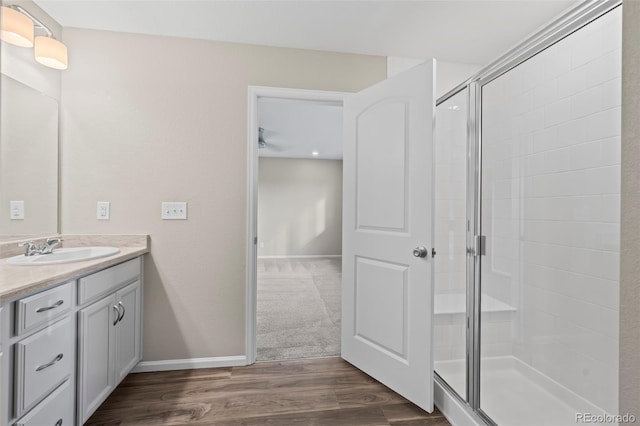 13870 Ash Cir, Brighton, CO 80602 - bathroom with vanity, a stall shower, and wood finished floors