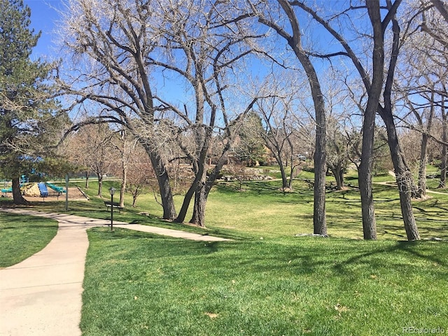 view of home's community with a lawn and a playground