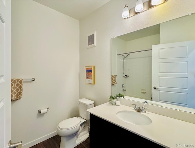 full bathroom featuring vanity, toilet, tiled shower / bath combo, and hardwood / wood-style floors