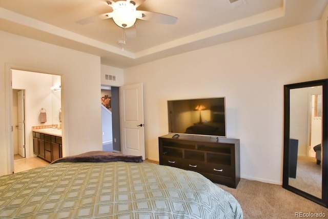 18709 E 47th Dr, Denver, CO 80249 - bedroom with light carpet, a tray ceiling, visible vents, and ensuite bathroom