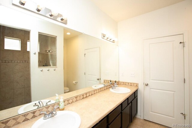 18709 E 47th Dr, Denver, CO 80249 - bathroom with a tile shower, a sink, and double vanity