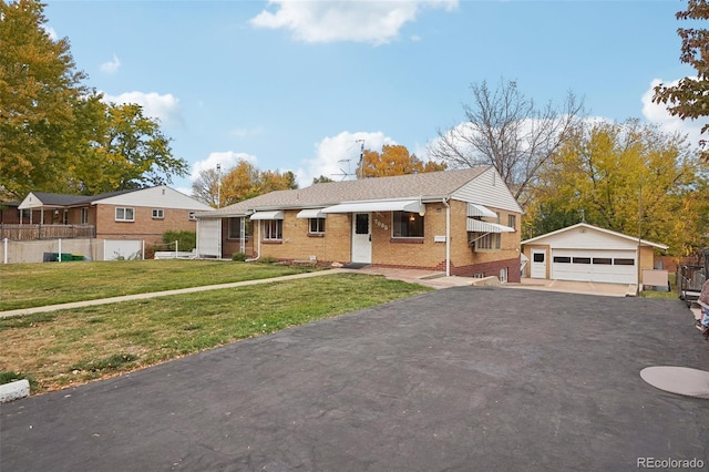 view of front of house featuring a garage, an outdoor structure, and a front lawn