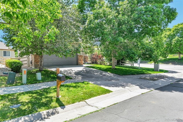 14944 E Archer Cir, Aurora, CO 80012 - obstructed view of property with brick siding, driveway, and a front lawn
