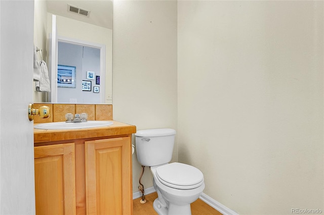 14944 E Archer Cir, Aurora, CO 80012 - bathroom with toilet, vanity, baseboards, and wood finished floors