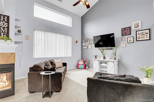 14944 E Archer Cir, Aurora, CO 80012 - living area featuring high vaulted ceiling, a ceiling fan, a tiled fireplace, and baseboards