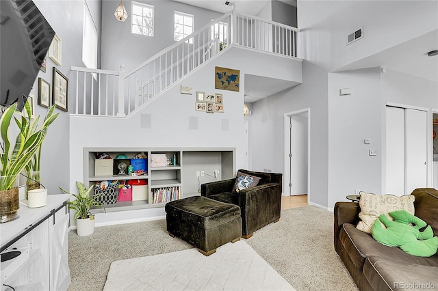 14944 E Archer Cir, Aurora, CO 80012 - living room with a towering ceiling, stairs, and baseboards