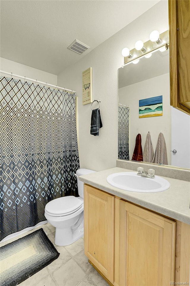 14944 E Archer Cir, Aurora, CO 80012 - bathroom featuring vanity, toilet, and marble finish floors