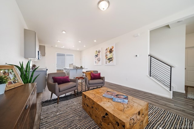 living area featuring recessed lighting, stairway, baseboards, and dark wood finished floors