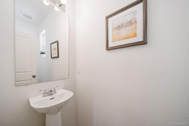 bathroom featuring visible vents and a sink