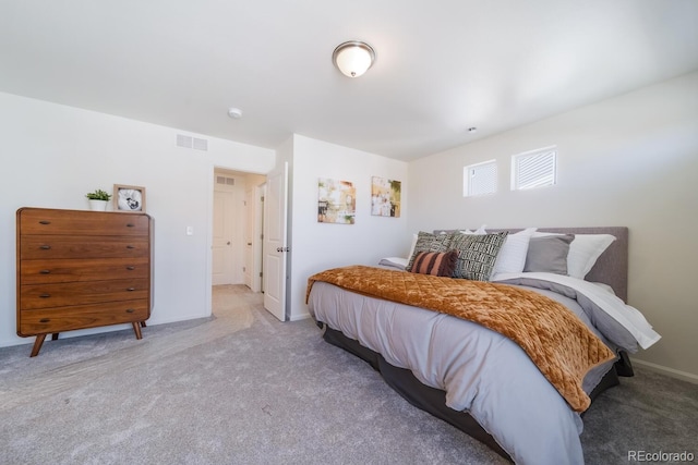 carpeted bedroom featuring visible vents and baseboards