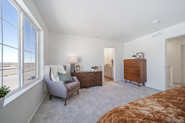 bedroom featuring light carpet, visible vents, connected bathroom, and baseboards