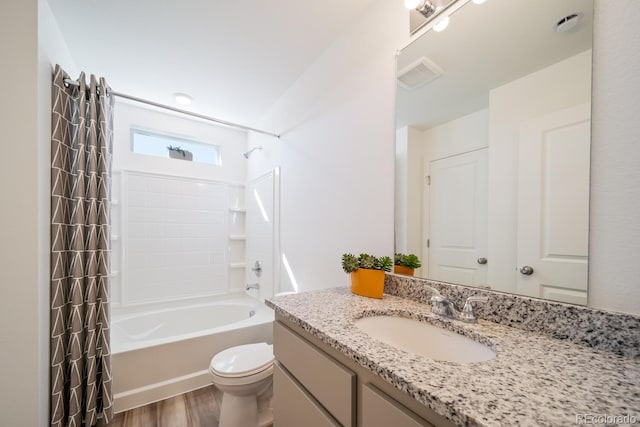 bathroom featuring vanity, wood finished floors, visible vents, toilet, and shower / tub combo with curtain