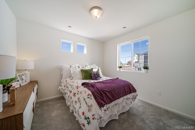 carpeted bedroom featuring baseboards