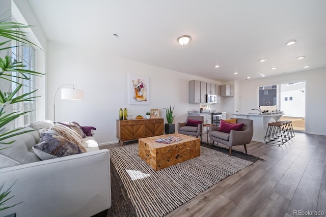 living room with recessed lighting, wood finished floors, and baseboards