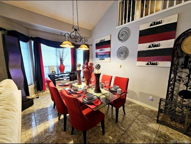 dining room featuring baseboards, tile patterned flooring, and lofted ceiling