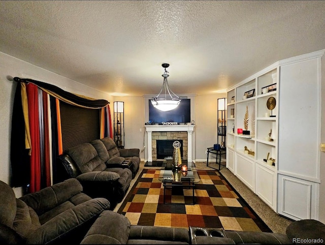 living area featuring built in shelves, a textured ceiling, and a fireplace