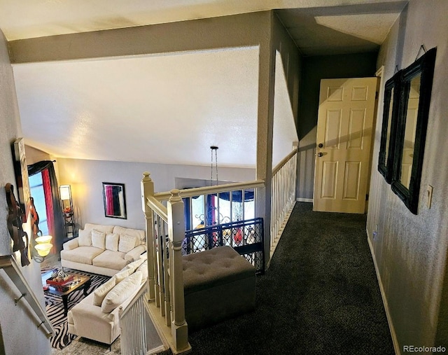 hall featuring dark colored carpet