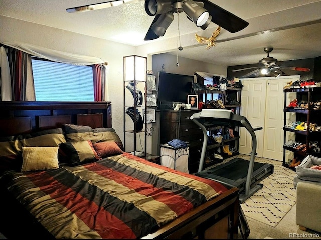 bedroom with a textured ceiling and a ceiling fan