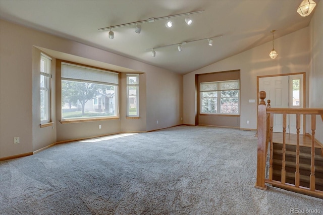 carpeted spare room featuring lofted ceiling