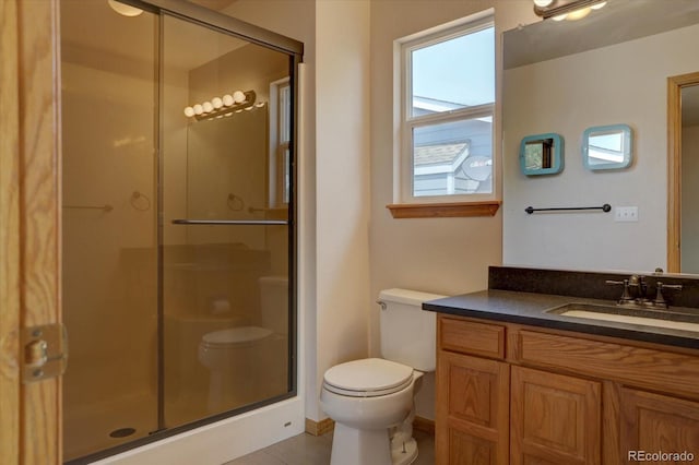 bathroom with tile patterned flooring, vanity, an enclosed shower, and toilet