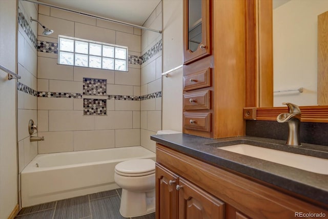 full bathroom with vanity, toilet, and tiled shower / bath