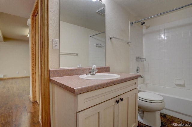 full bathroom featuring wood-type flooring, vanity, toilet, and tiled shower / bath combo