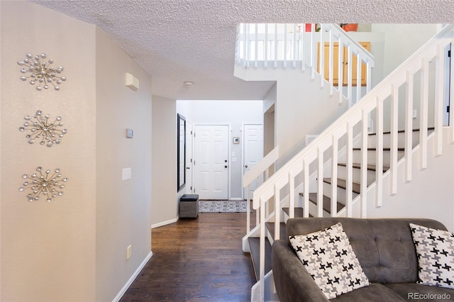 stairs with hardwood / wood-style flooring and a textured ceiling