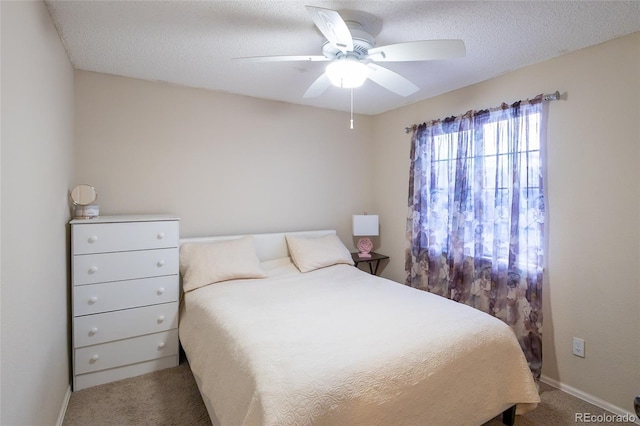 bedroom featuring a textured ceiling, ceiling fan, and carpet