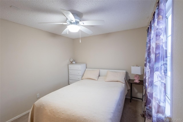 carpeted bedroom with a textured ceiling and ceiling fan