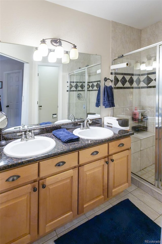 bathroom with vanity, tile patterned floors, and walk in shower