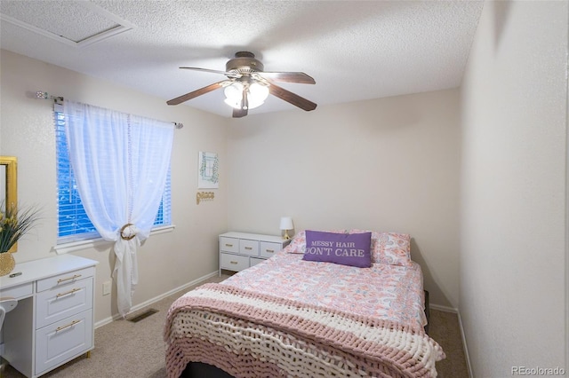 bedroom with light carpet, a textured ceiling, and ceiling fan