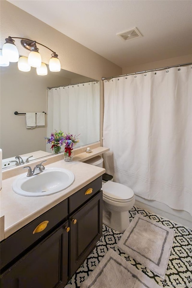 bathroom featuring vanity, tile patterned flooring, a shower with curtain, and toilet