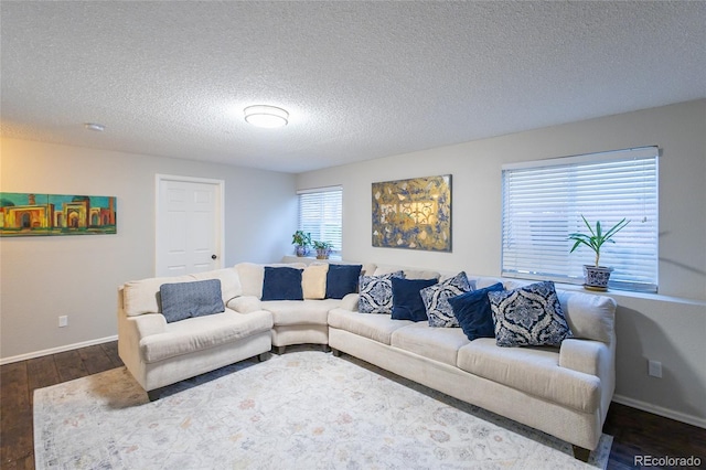 living room featuring dark hardwood / wood-style floors and a textured ceiling