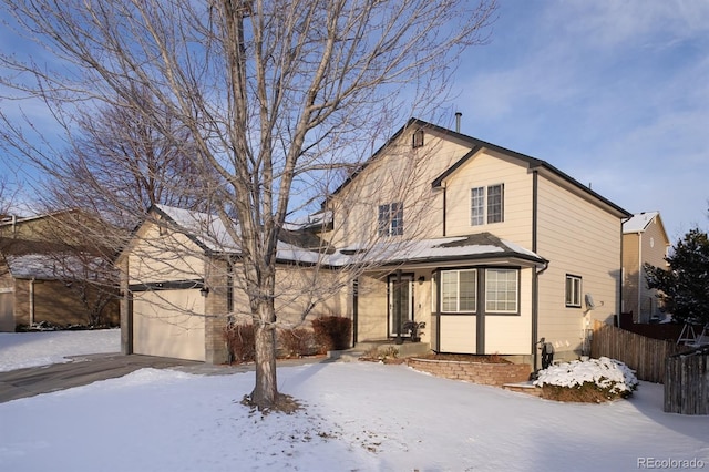 view of property featuring a garage and covered porch