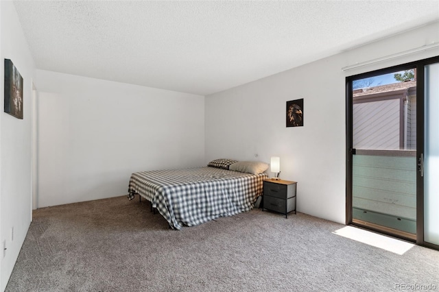bedroom featuring carpet floors and a textured ceiling