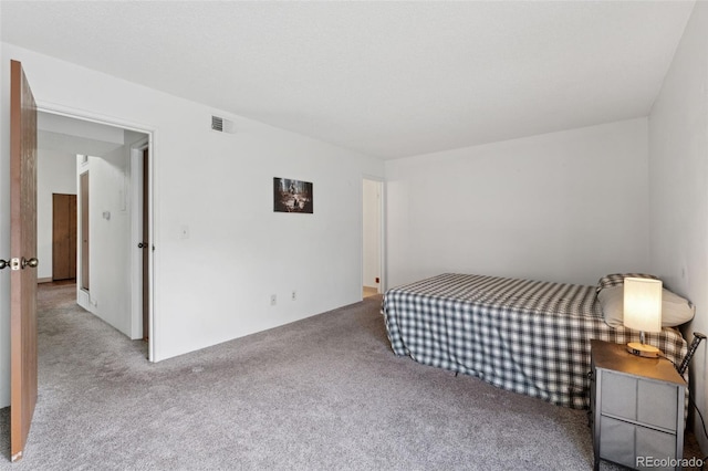 bedroom with visible vents and carpet flooring