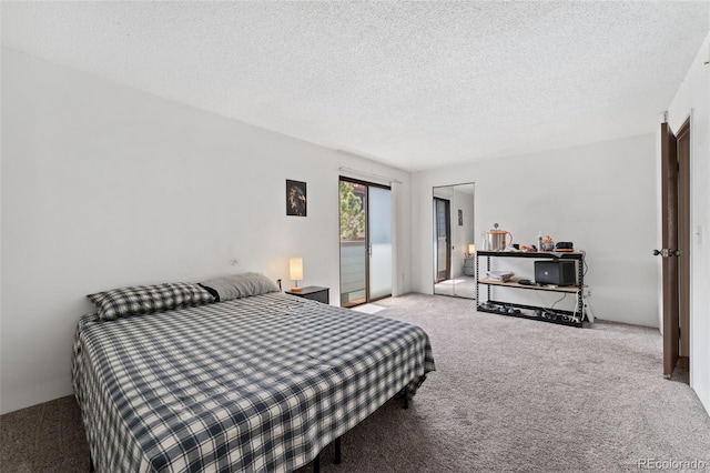 bedroom with carpet and a textured ceiling