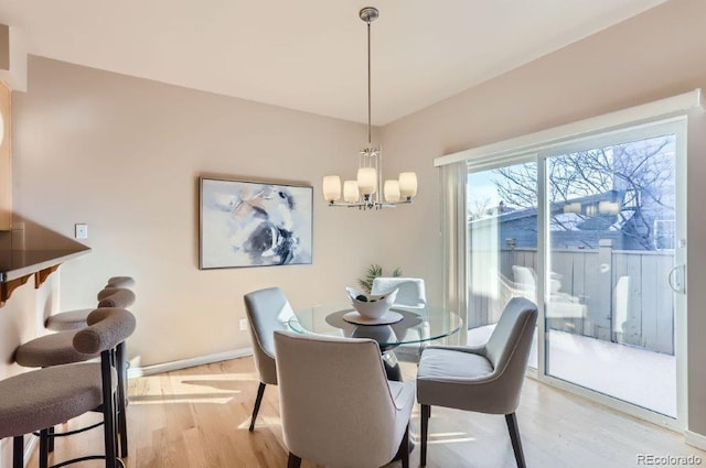 dining area featuring a notable chandelier and light wood-type flooring