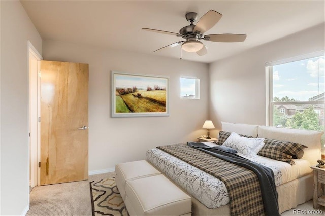 bedroom featuring ceiling fan and light colored carpet