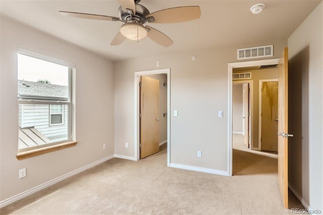 unfurnished bedroom with light colored carpet and ceiling fan