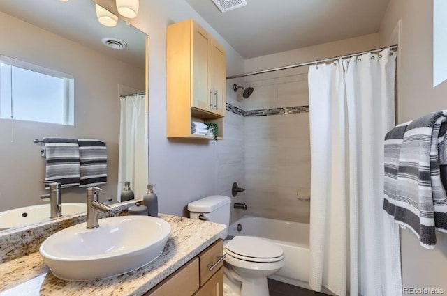 full bathroom with shower / bathtub combination with curtain, vanity, and toilet