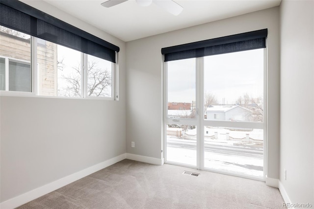 spare room featuring carpet and ceiling fan